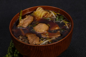 Thai style soup with meat and mushrooms