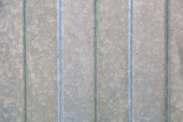 Fototapeta premium Background of corrugated gray metal sheet closeup