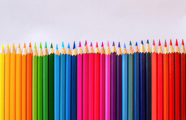 Colored pencils arranged in a white background