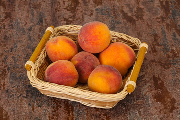 Peach heap in the wooden basket