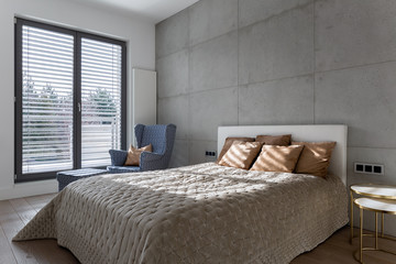 Elegant bedroom with concrete wall