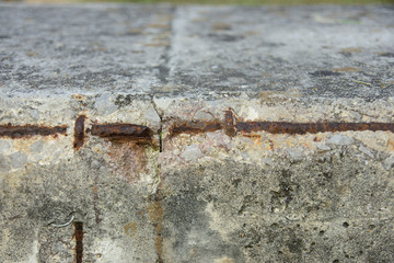 Detail of the exposed rusty reinforcement bars of a concrete structure