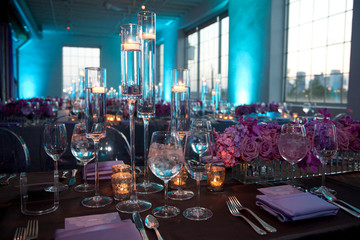 Low angle wide empty shot of table setting at a formal party at dusk.