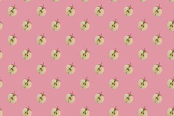 Seamless pattern of Apple slices on a pink background. Delicious juicy ripe fruit background, natural healthy diet food concept