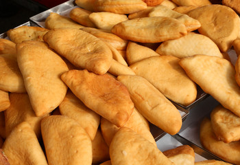 food called panzerotti stuffed with mozzarella and tomato on sal