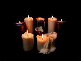 Burning candles on a black background.
