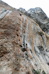 high imposing steep limestone wall overhanging rock without peop