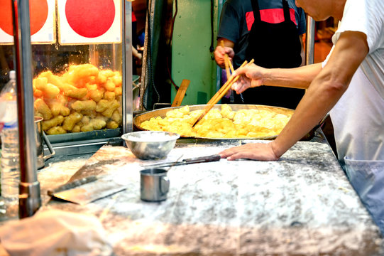 Fried flour snack called "Pa Tong Go", popular food. Street food, Yaowarat road at night, a popular place for travelers Bangkok Thailand.