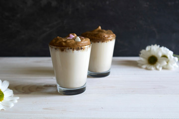 Dalgona coffee - the Korean coffee drink on wooden background, Dalgona coffee - instant coffee or espresso, whipped with sugar and hot water