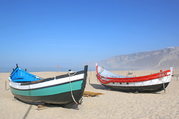 Fototapeta premium Traditional fishing boats on Nazare beach, Portugal 