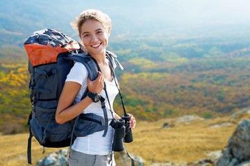 Travels female happy and smiling during a hike