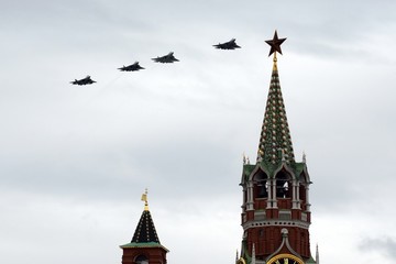 Fototapeta na wymiar Fifth-generation Russian multi-purpose fighters Su-57 during the air parade dedicated to the 75th anniversary of the Victory fly in the sky over Red Square