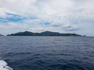 island mountain hill ferry transport ocean sea tropical gulf thailand grey sky cloud koh phangha ko samui tao dive ship