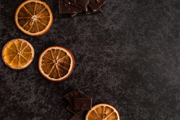 bitter chocolate and orange slices on the table