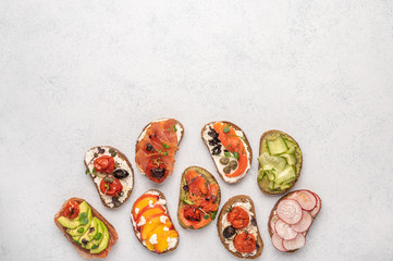 Homemade sandwiches with bread and various ingredients and spices on a light background. Healthy delicious food for breakfast and lunch