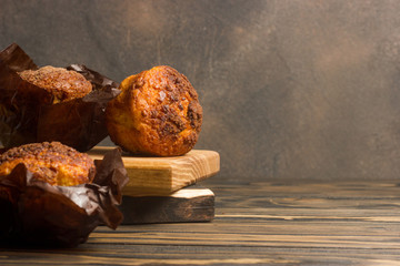 Homemade delicious muffins on wooden background close-up