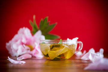 Obraz na płótnie Canvas summer flower tea from rose petals in a glass cup