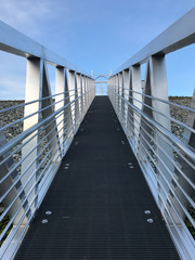 Looking up a steep, stainless steel marina boat dock ramp 