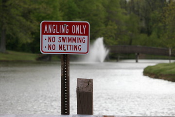 Angling Only Sign With Lake In Background