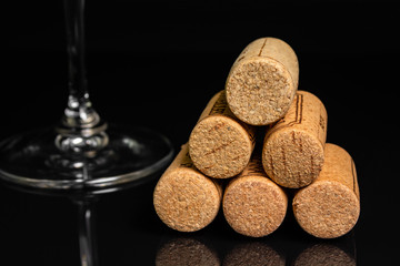 red wine in a glass on a high leg on a black background