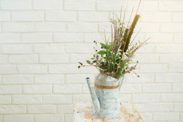 beautiful jug with decor from plants on a white background