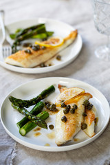 Lemon sole with butter and capers sauce and asparagus
