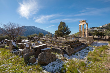 Fototapeta na wymiar Ruins of Athena pronaia temple in Delphi with snow
