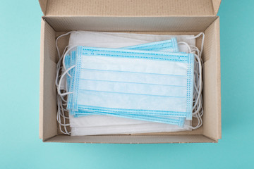 Coronavirus prevention concept. Top above overhead view photo of a box full of different masks...