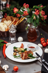 Fototapeta na wymiar Barbecued marinated turkey or chicken meat shish kebab skewers with ketchup sauce and grilled vegetables on rustic wooden table background. Traditional barbecue grill food