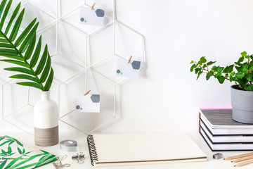 Home creative desk with an open sketchbook and notebooks.