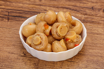 Pickled champignons in the bowl