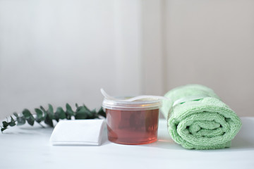 Sugar depilation set. A bowl of honey paste, spatula, strips and a towel. Spa and body care concept. sugar paste or hair removal wax