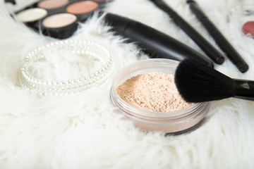 Loose powder and brush close-up. Decorative cosmetics.