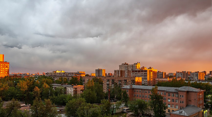 The city is lit by the setting sun. City landscape.