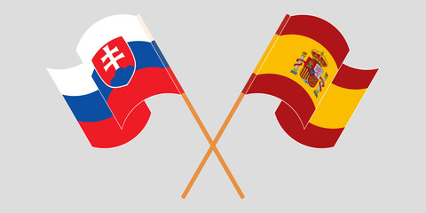 Crossed and waving flags of Slovakia and Spain