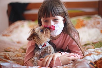 girl with a dog at home playing