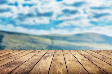 The empty wooden table top on nature background.