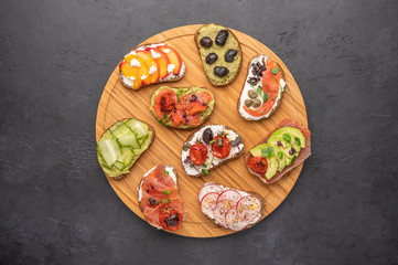 Homemade sandwiches with bread and various ingredients and spices on a light background. Healthy delicious food for breakfast and lunch