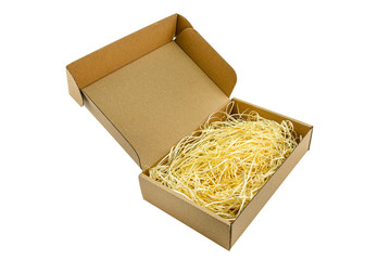 Small cardboard made of corrugated cardboard with an opening upper part filled with hay, isolated on a white background with a clipping path.