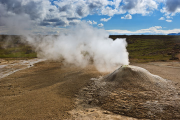 Beautiful colourful Icelandic landscape lava fields mountain geysers zigzag road and moss-covered stones Namafjall, Iceland.