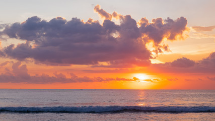 Panorama of colorful clouds and ocean at sunset at Kuta Beach on the island of Bali in Indonesia....