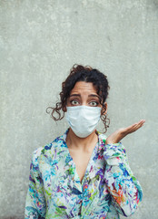 Young adult woman green eyes portrait wearing a surgical mask with copy space