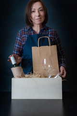 delivery service woman packing bag box packer shipping wine glasses sommelier