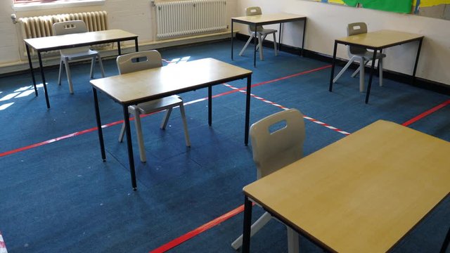 4K: Empty School Classroom with Tape on the floor between desks for Social Distancing to prevent the spread of COVID-19 Coronavirus in Education. Crane Shot. Stock Video Clip Footage