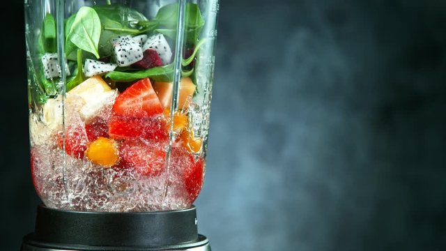 Fresh fruit and vegetables smoothie blended in blender, back view. Healthy eating concept. Super slow motion filmed on high speed cinematic camera.