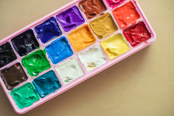 pink gouache paint pallet on neutral background - watercolor or acrylic