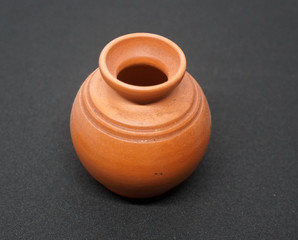 Vintage brown jug placed on black background 