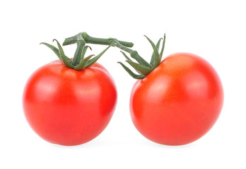 Two ripe cherry tomatoes isolated on a white background. Two vegetables on branch with sepals.