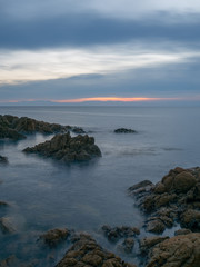 long exposure of sea and rocks at sunset 