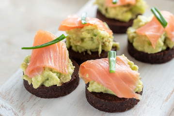 Avocado paste with salmon on wholemeal bread